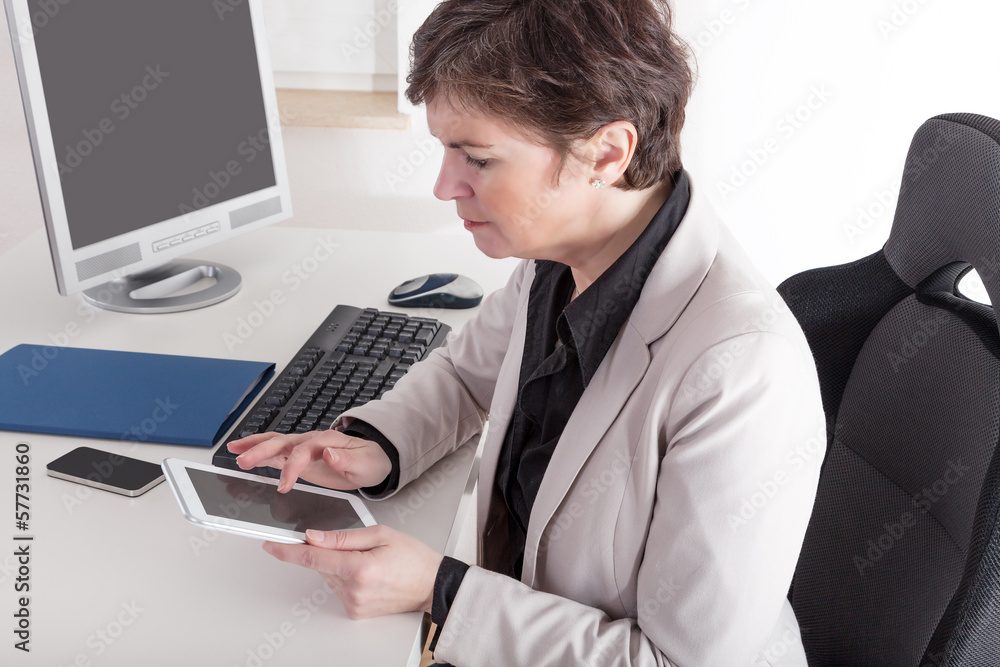 Businesswoman in office with tablet PC Businesswoman in office with tablet PC