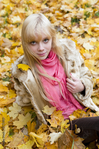 Beautiful blond girl in autumn park