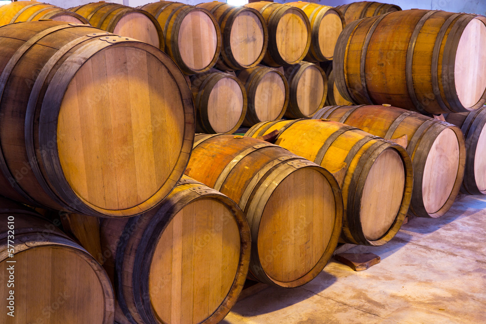 wine wooden oak barrels stacked in a row at winery wine wooden oak barrels stacked in a row at winery