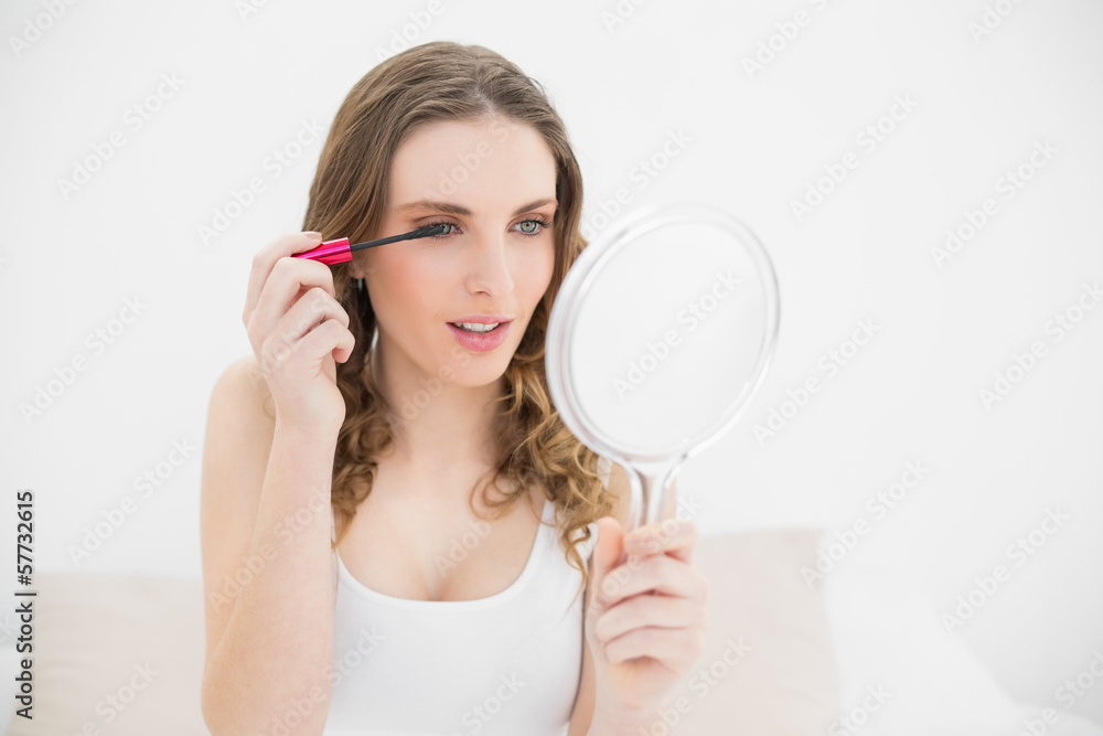 Pretty woman using mascara