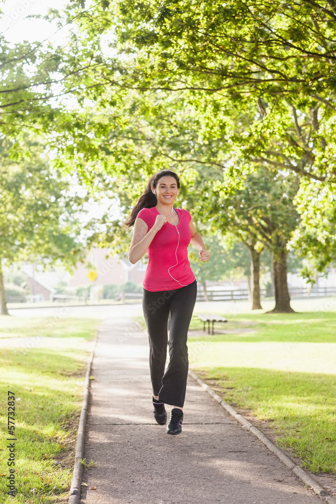 Gorgeous sporty woman jogging in a park Gorgeous sporty woman jogging in a park