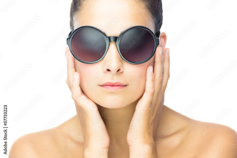 Front view of serious woman woman wearing round sunglasses Front view of serious woman woman wearing round sunglasses