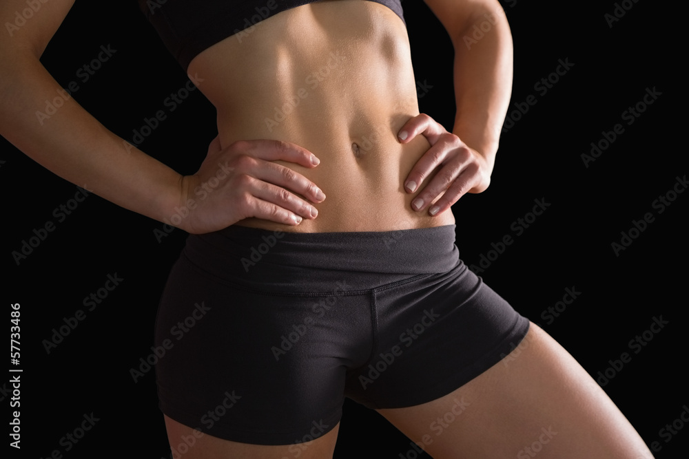 Fototapeta premium Mid section of slim fit woman posing in sportswear
