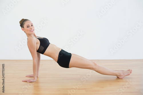 Attractive fit woman in sportswear doing yoga pose