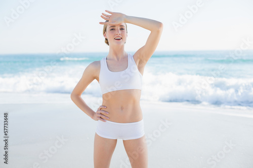 Cheerful slender woman touching her forehead © lightwavemedia