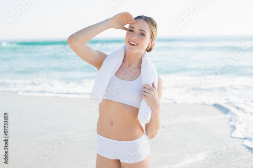 Smiling slender woman holding white towel © lightwavemedia