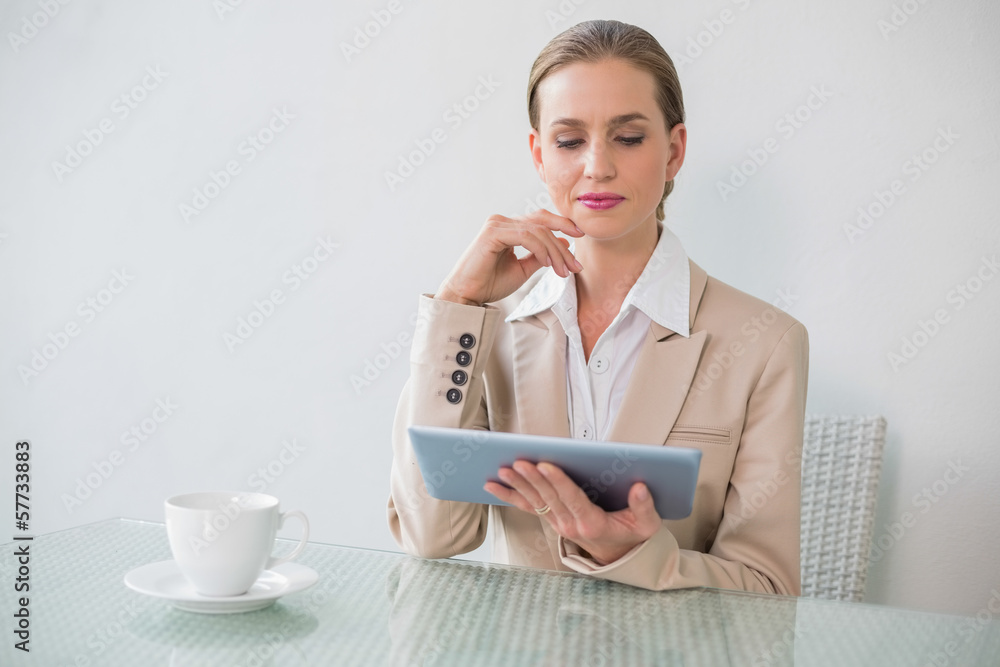 Thoughtful stylish businesswoman holding tablet Thoughtful stylish businesswoman holding tablet