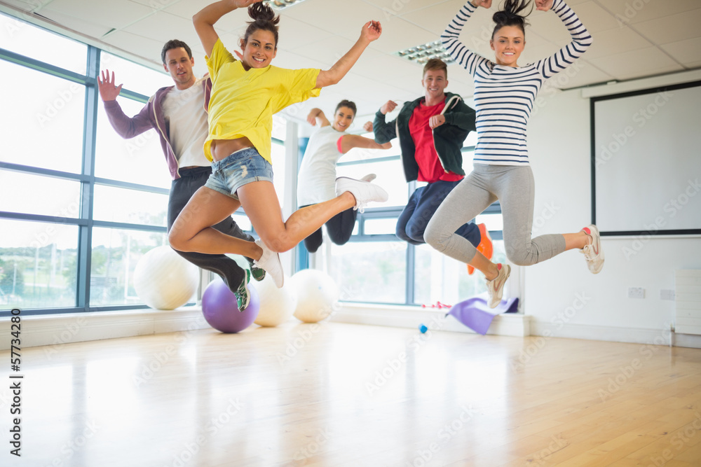 Fit people jumping in bright exercise room Fit people jumping in bright exercise room