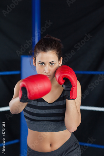 Portrait of a beautiful woman in red boxing gloves