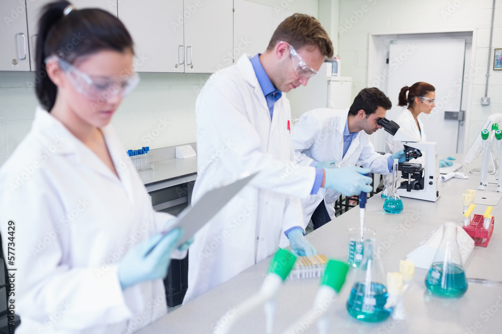 Researchers carrying out experiments in the lab Researchers carrying out experiments in the lab