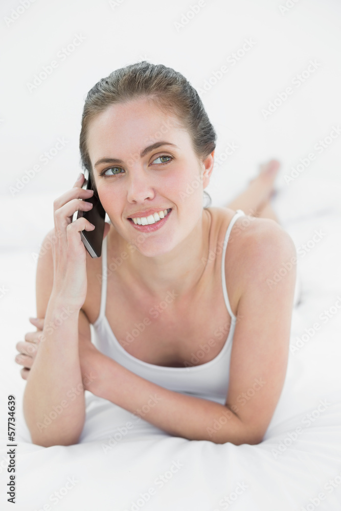 Woman using mobile phone in bed Woman using mobile phone in bed