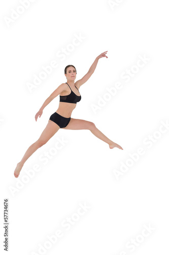 Sporty woman jumping on white background © lightwavemedia