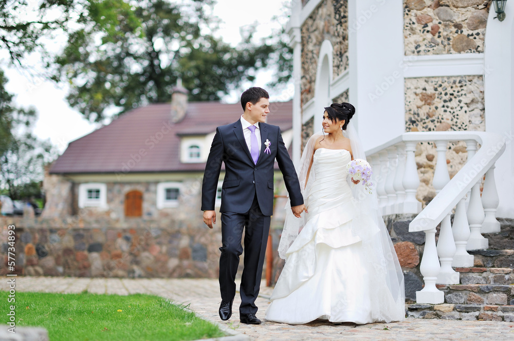 Bride and groom walking in an old town