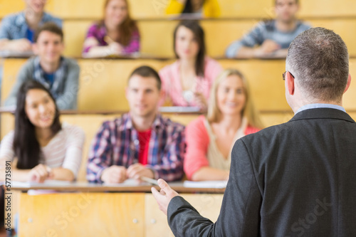 Elegant teacher with students sitting at the lecture hall