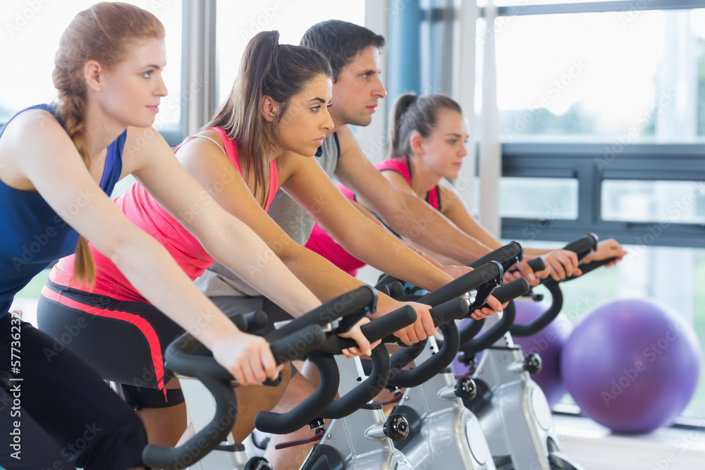 Four people working out at spinning class Four people working out at spinning class