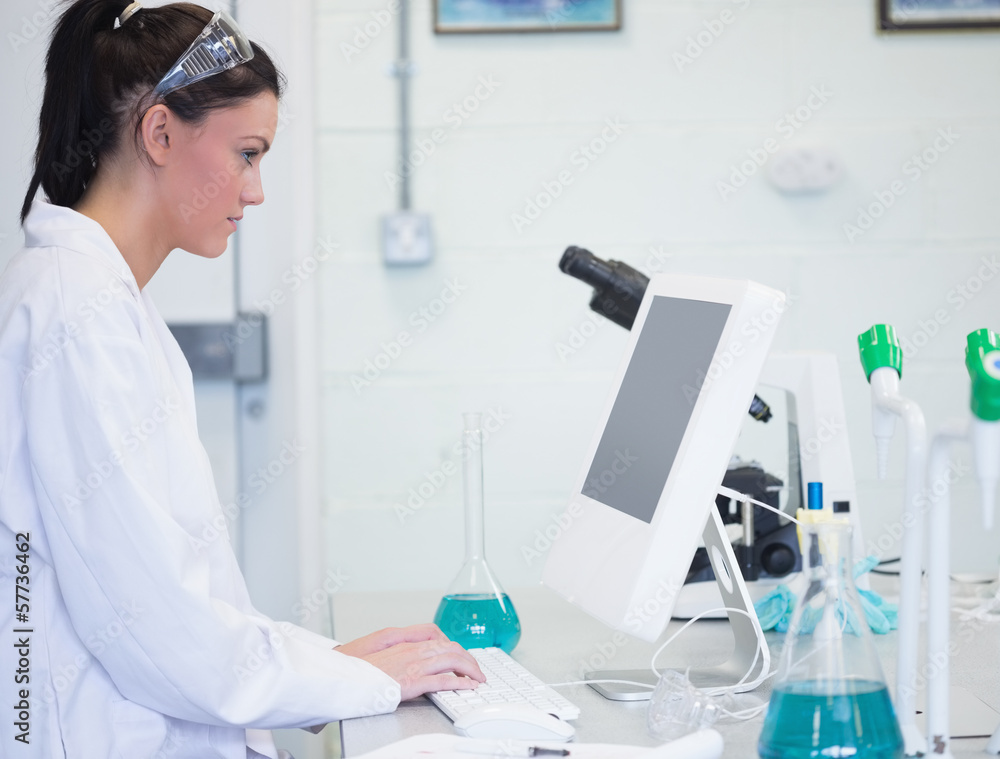 Young female researcher using computer in lab Young female researcher using computer in lab