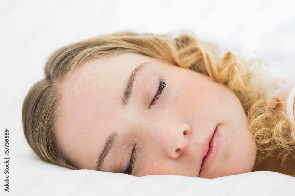 Pretty content blonde lying in bed resting with closed eyes Pretty content blonde lying in bed resting with closed eyes