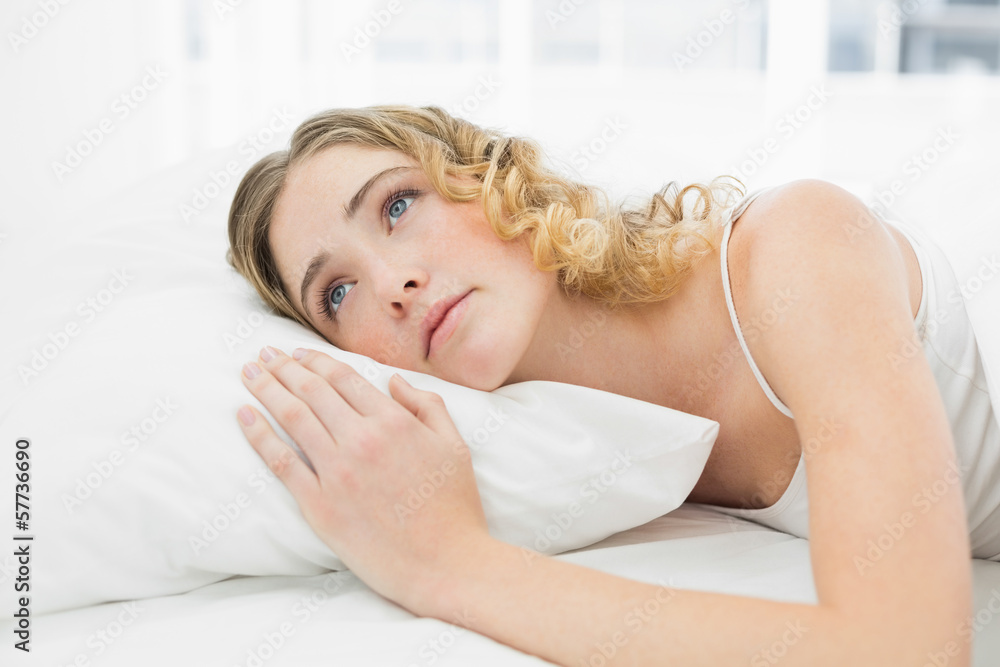 Fototapeta premium Pretty calm blonde lying in bed resting looking up