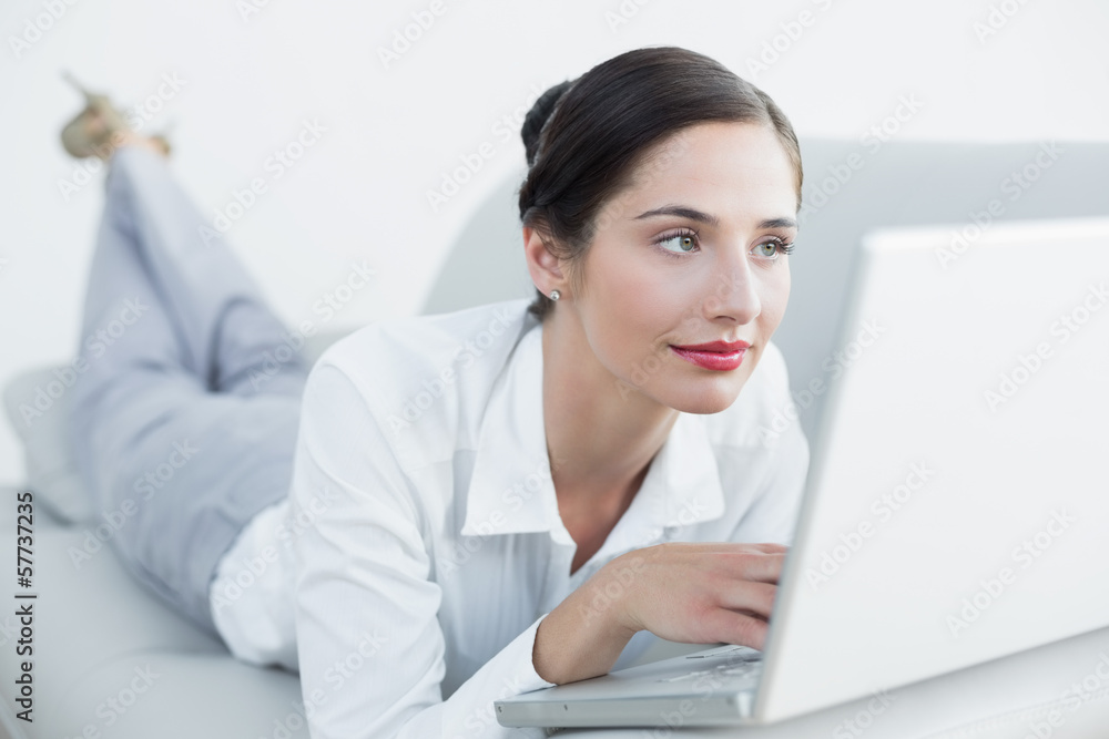 Relaxed beautiful woman using laptop on sofa Relaxed beautiful woman using laptop on sofa