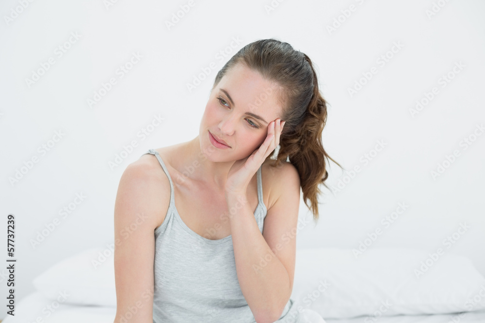 Fototapeta premium Woman with headache sitting in bed
