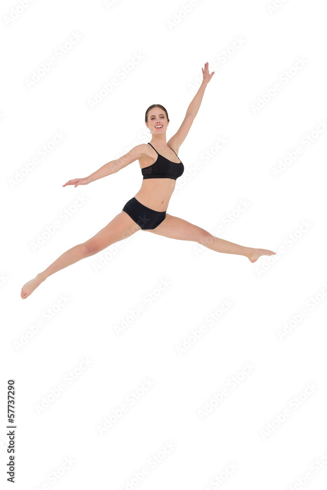 Sporty woman jumping on white background