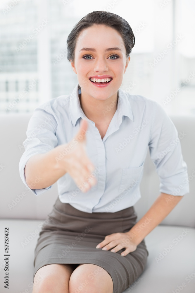 Smiling well dressed woman offering a handshake Smiling well dressed woman offering a handshake