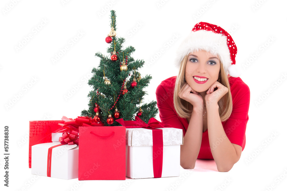 Young woman lying down with christmas tree and gifts isolated on Young woman lying down with christmas tree and gifts isolated on
