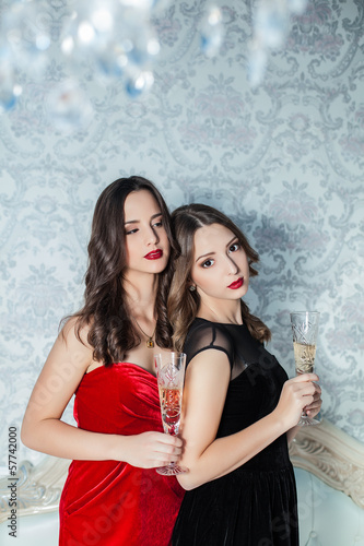 elegant young womans with champagne glasses at celebration