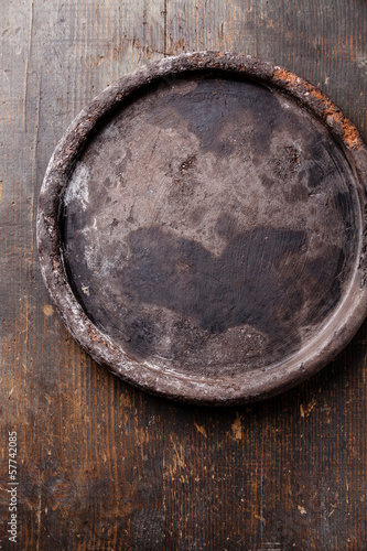 Old stone tray on wooden texture background © Natalia Lisovskaya