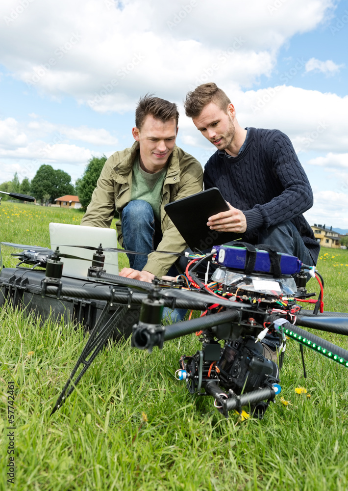 Technicians Discussing Over Digital Tablet By UAV