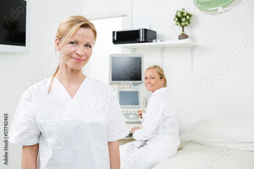 Happy Female Gynecologists In Clinic