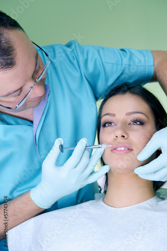 Beautiful woman gets an injection in her face