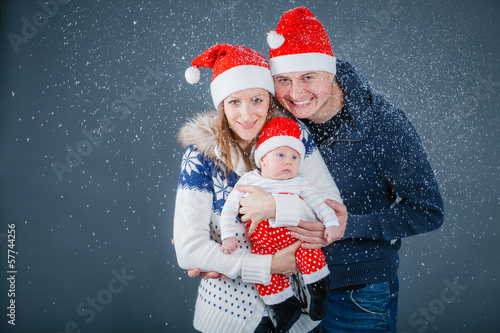 Portrait of happy family in Santa's hat