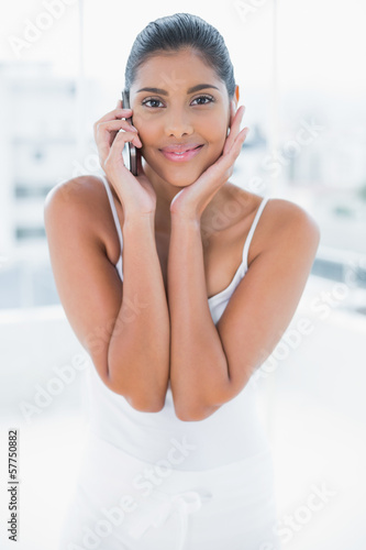 Free Download Smiling toned brunette phoning with mobile phone - GFXLoad