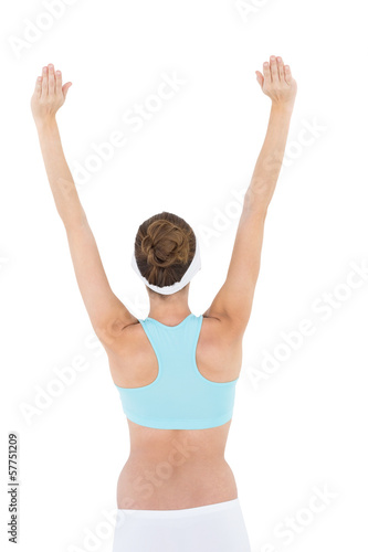 Rear view of brunette woman raising her arms wearing sportswear