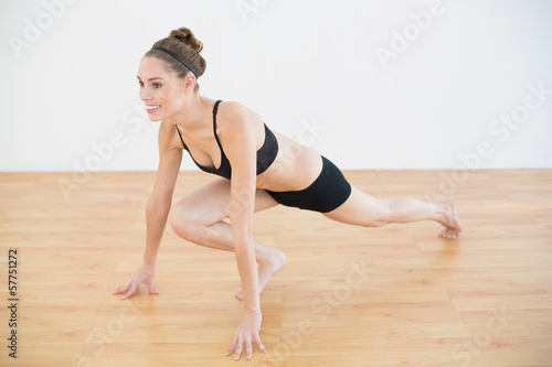 Sporty woman in sportswear stretching her leg