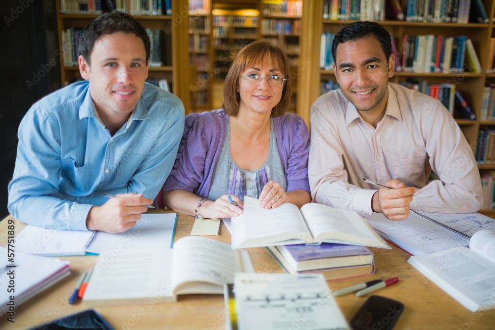 Adult students studying together in the library Adult students studying together in the library