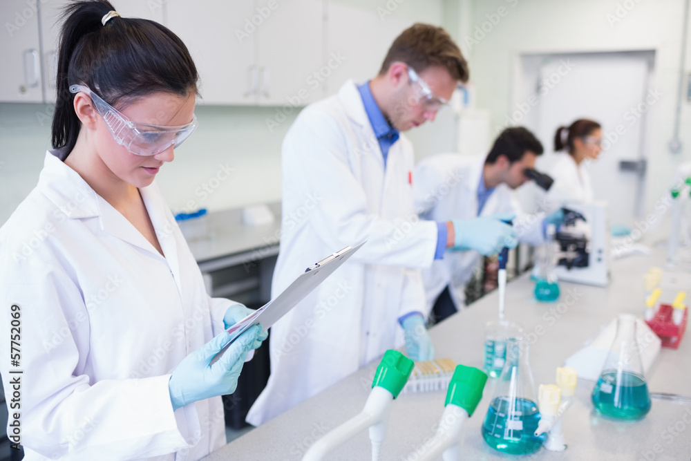 Researchers carrying out experiments in the lab Researchers carrying out experiments in the lab