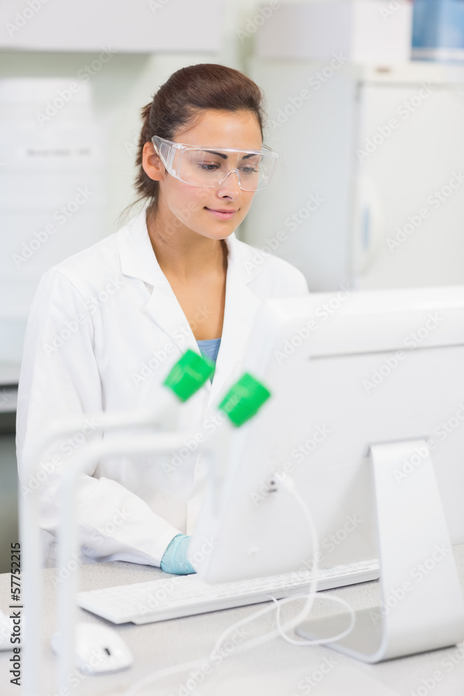 Female researcher using a computer in the lab Female researcher using a computer in the lab