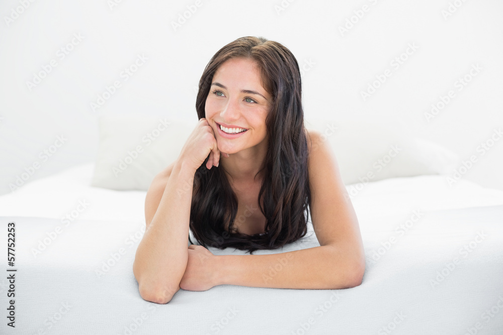 Happy woman looking away in bed Happy woman looking away in bed
