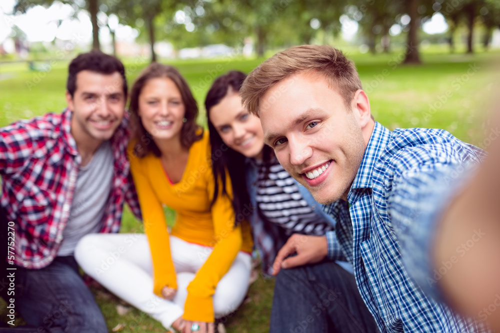 Fototapeta premium Portrait of cheerful college students in park