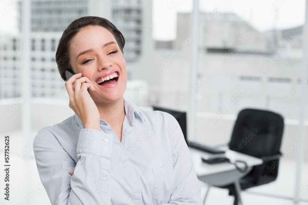 Cheerful elegant businesswoman using cellphone in office Cheerful elegant businesswoman using cellphone in office