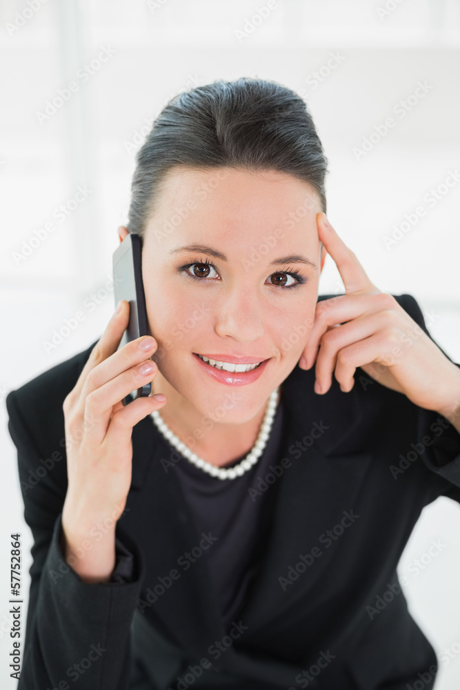 Smiling elegant businesswoman using cellphone Smiling elegant businesswoman using cellphone