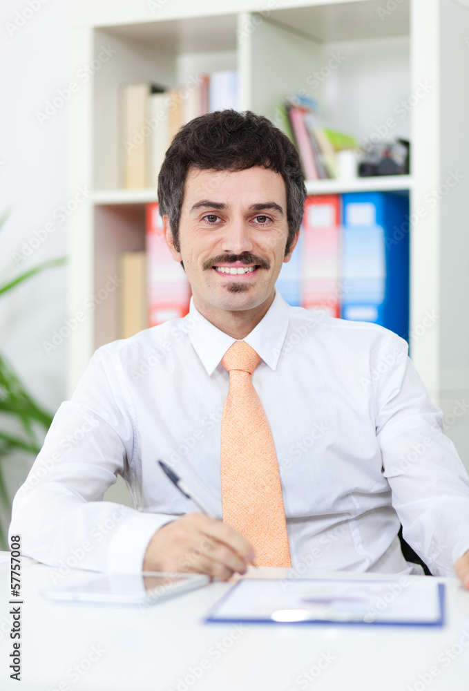 Smiling businessman in the office Smiling businessman in the office
