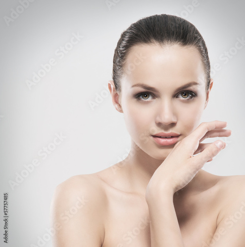 Beauty portrait of a young girl on a grey background