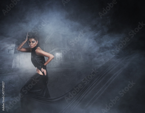 Fashion shoot of a sexy woman in a black long dress © Acronym