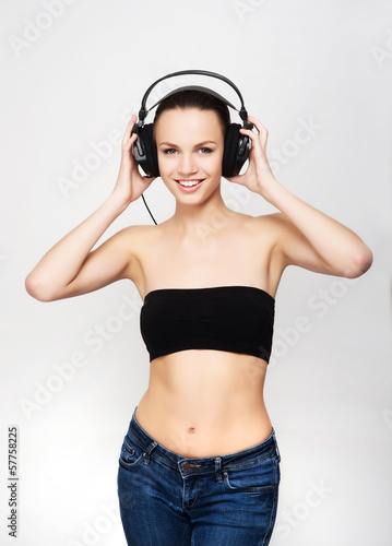 A young and fit teenage girl listening to music in headphones