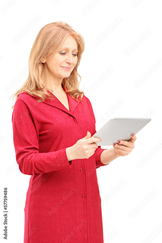 Mature smiling woman looking at tablet Mature smiling woman looking at tablet