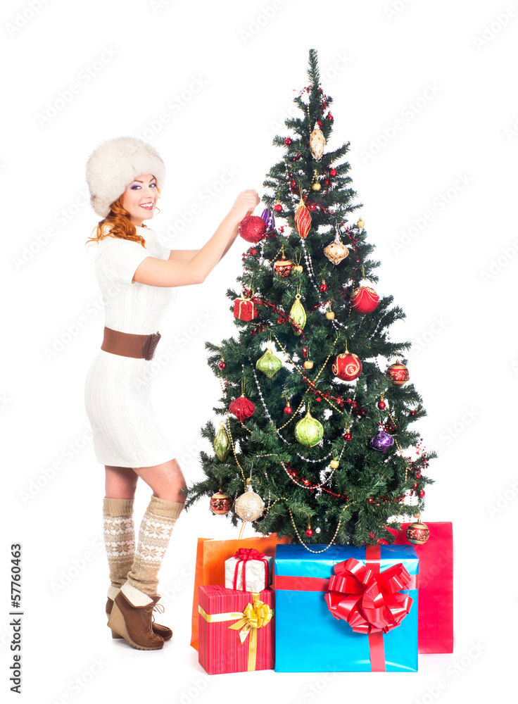 A beautiful woman decorating the Christmas tree A beautiful woman decorating the Christmas tree