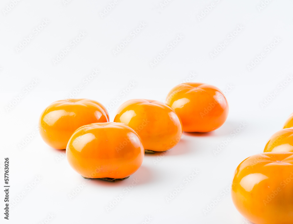 Fresh, delicious, organic Fuyu Persimmon on white background Fresh, delicious, organic Fuyu Persimmon on white background